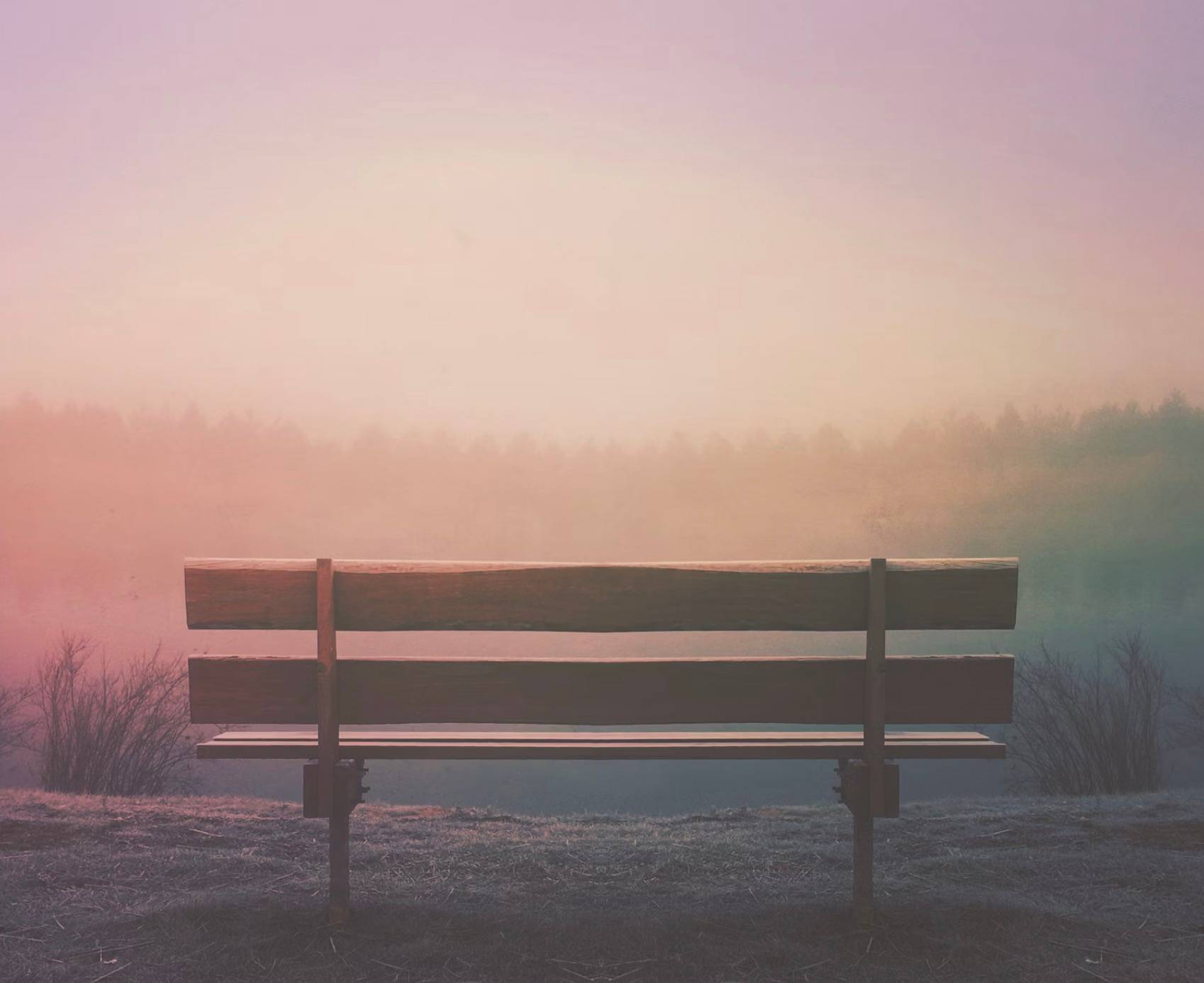 an empty bench at sunrise