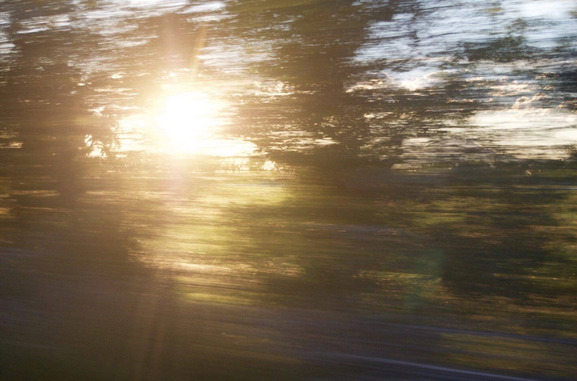 a car gaining more and more speed - the blurry view of movement out the window