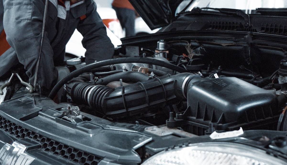 man repairing a car