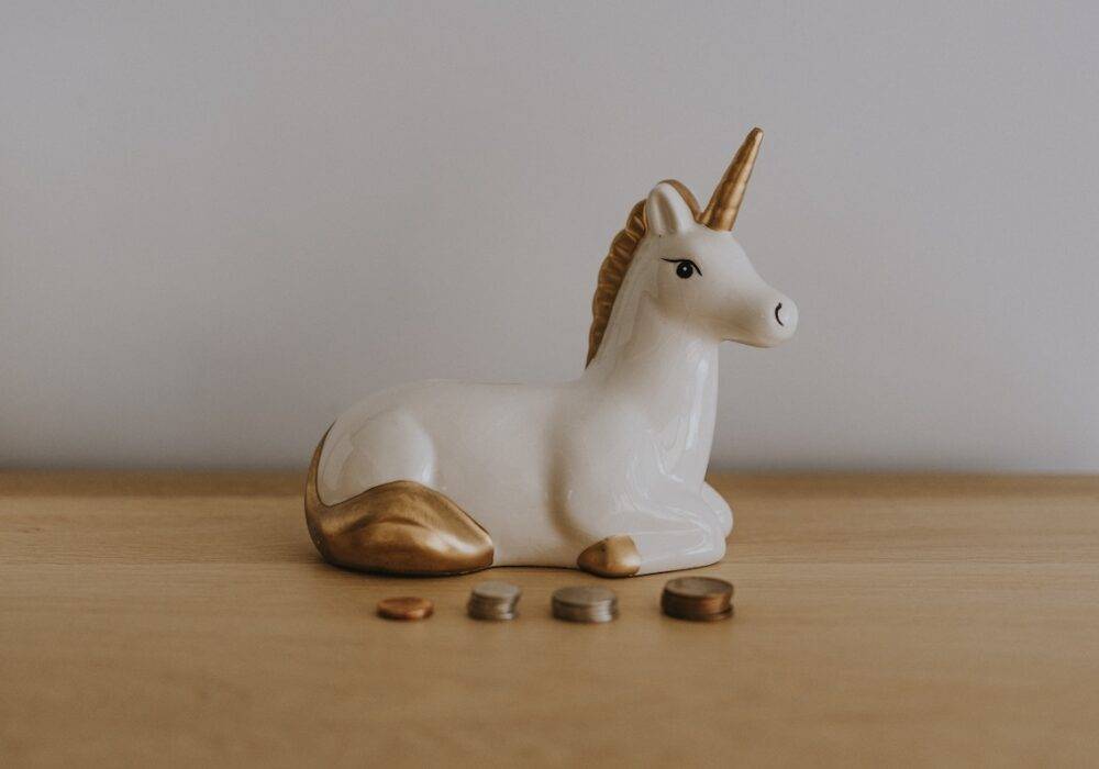 unicorn piggy bank with coins