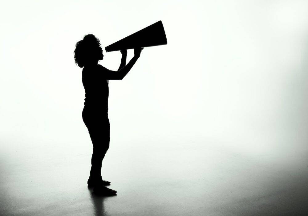 woman holding a loudspeaker