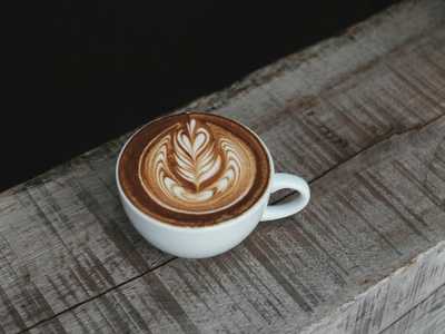 Cappuccino in white ceramic teacup with latte art