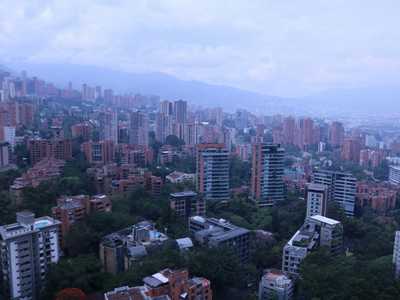 View of Medellin city from a tall building, with mountains in the background
