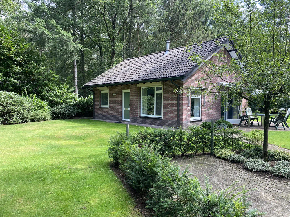 Tuin van Zonzicht – terras met zitplekken in een ruime bostuin, midden in de bosrijke natuur.