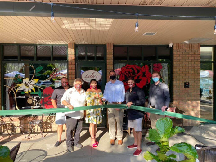 OPENING ACTION: Jodi Ricci, third from the left, and her husband, Michael Mota, fourth from the left, cut the ribbon at the opening of Lola’s Lounge and Cantina in Smithfield. Joining them, from left, are Scott Connory, vice president of sales; Joe Ricci, co-owner; Smithfield Town Manager Randy Rossi; and Town Councilman Sean Kilduff. / COURTESY LOLA’S LOUNGE AND CANTINA OPENING ACTION: Jodi Ricci, third from the left, and her husband, Michael Mota, fourth from the left, cut the ribbon at the opening of Lola’s Lounge and Cantina in Smithfield. Joining them, from left, are Scott Connory, vice president of sales; Joe Ricci, co-owner; Smithfield Town Manager Randy Rossi; and Town Councilman Sean Kilduff. / COURTESY LOLA’S LOUNGE AND CANTINA