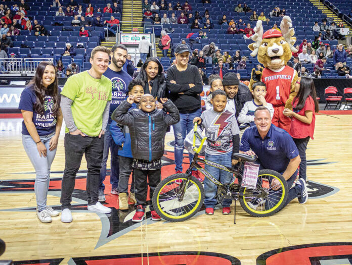 HOT WHEELS: Barnum Financial Group employees participate in the Foundation for Life’s Bikes for Kids program.  COURTESY BARNUM FINANCIAL GROUP