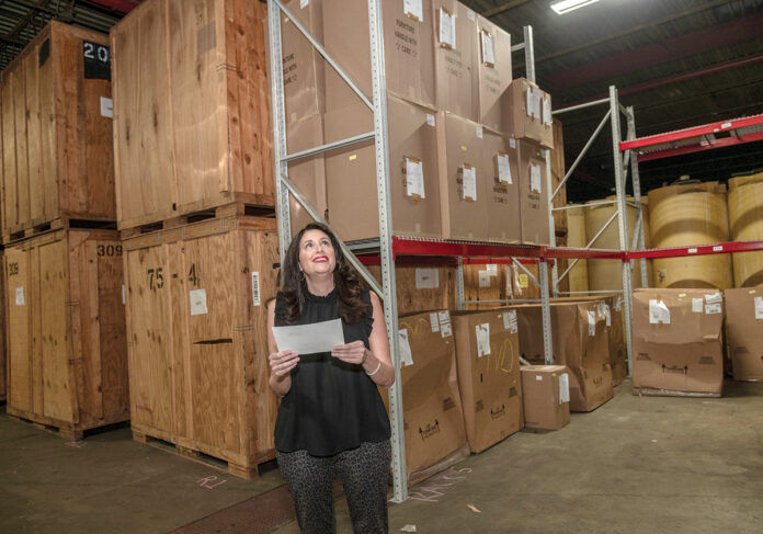 ON THE MOVE: Christine Crum, owner of Gentry Moving and Storage, makes her way around the company storage facility. / PBN PHOTO/MICHAEL SALERNO