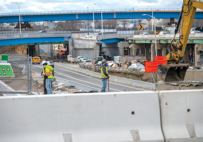 UP-ROUTED: Construction workers are on-site at the Westminster Street overpass, part of the Route 6-10 connector project in Providence. Visible in the background is the “flyover” bridge, a major feature of the new design for the busy exchange. / PBN PHOTO/MICHAEL SALERNO UP-ROUTED: Construction workers are on-site at the Westminster Street overpass, part of the Route 6-10 connector project in Providence. Visible in the background is the “flyover” bridge, a major feature of the new design for the busy exchange. / PBN PHOTO/MICHAEL SALERNO
