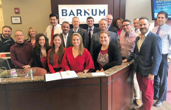 SEEING RED: Barnum Financial Group employees collectively wear red to support heart and cardiovascular health. / COURTESY BARNUM FINANCIAL GROUP