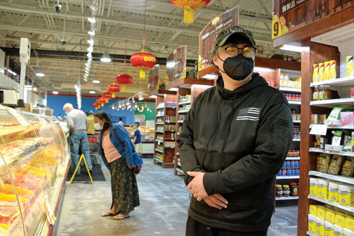 SPECIAL ÂFLAVOR: Leo Lin, foreground, is the manager of Good Fortune Supermarket, a Providence grocery store that offers a wide variety of Asian foods. / PBN PHOTO/ELIZABETH GRAHAM SPECIAL ÂFLAVOR: Leo Lin, foreground, is the manager of Good Fortune Supermarket, a Providence grocery store that offers a wide variety of Asian foods. / PBN PHOTO/ELIZABETH GRAHAM