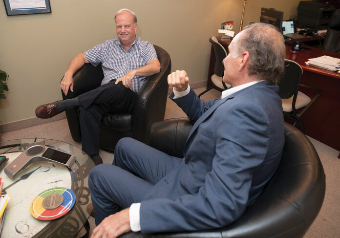 IN DISCUSSIONS: David Marble, left, CEO and president of OSHEAN Inc., a nonprofit whose objective is the creation of a broadband network in Rhode Island, talks with Mark Montalto, OSHEAN vice president of business development.  PBN PHOTO/MICHAEL SALERNO
