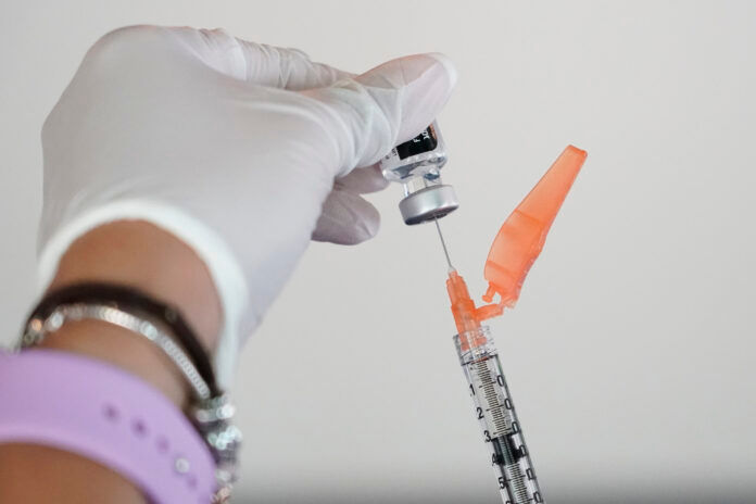 ROUGHLY 130,000 Rhode Islanders became eligible for booster shots of Pfizer's COVID-19 vaccine Friday. / AP FILE PHOTO/ROGELIO V. SOLIS