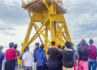 FUTURE WORKFORCE? Rhode Island high school students participating in a career pathway program for offshore wind jobs ride in a boat circling a Block Island Wind Farm turbine. /  COURTESY LUCKY DAWG PHOTOGRAPHY/DOUG LEARNED