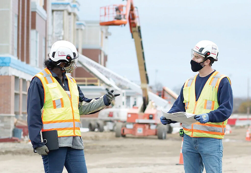 BUILDING BLOCKS: R.I.’s manufacturers and construction companies helped keep the local economy going after COVID-19 hit. Above,  Gilbane Building Co. employees work on the new East Providence High School in 2021.  COURTESY GILBANE BUILDING CO.