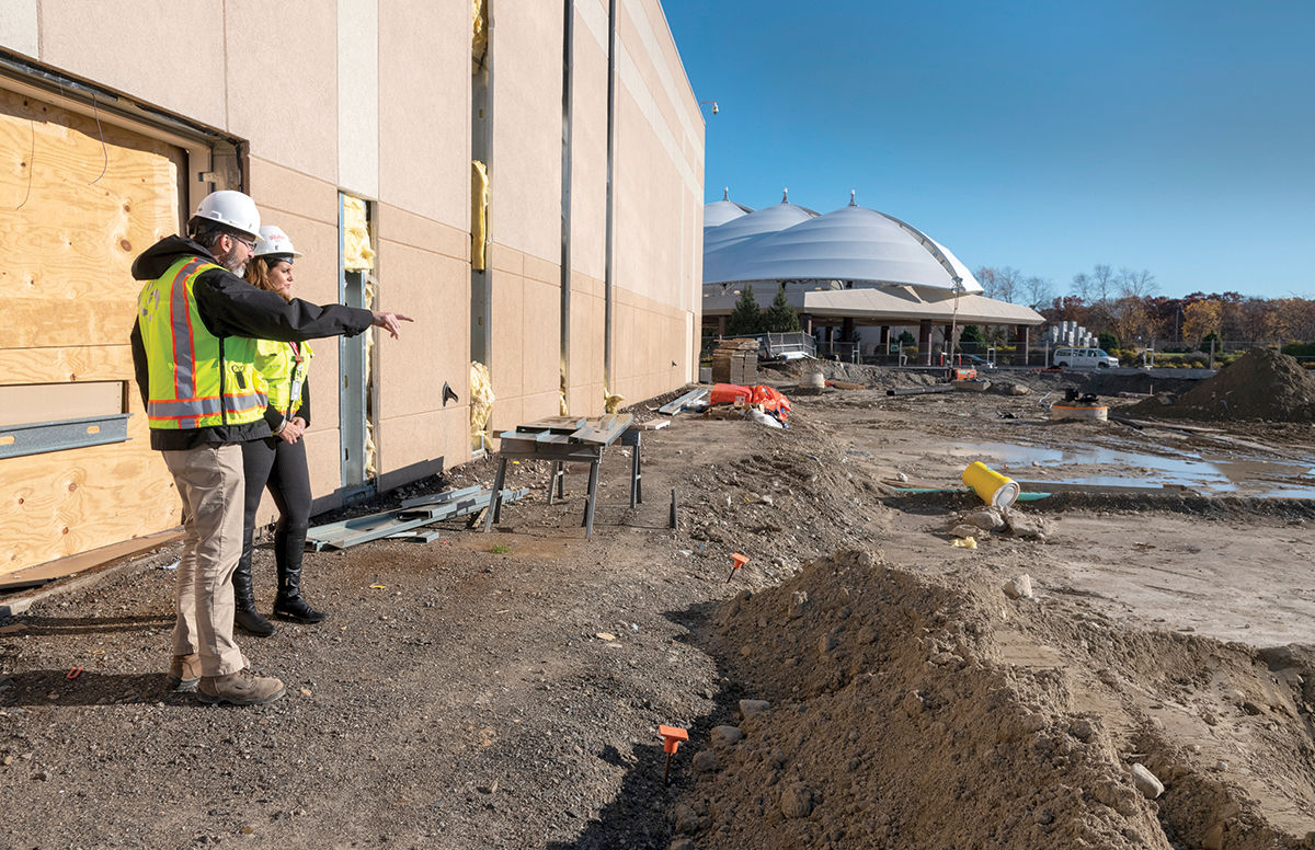 SPACE MAKING: Derek Sharp, left, senior project manager for Suffolk Construction Co., and Kim Ward, Bally’s Corp.’s regional executive director of public and community affairs, check the progress on the $100 million expansion project at Bally’s Twin River Lincoln Casino. / PBN PHOTO/MICHAEL SALERNO