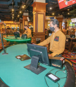 CARD CARRYING: Blackjack dealers Rithy Sen, foreground, and Hoa Lam are ready for gamblers to step to the tables on the casino floor at Bally’s Twin River Lincoln Casino. / PBN PHOTO/MICHAEL SALERNO