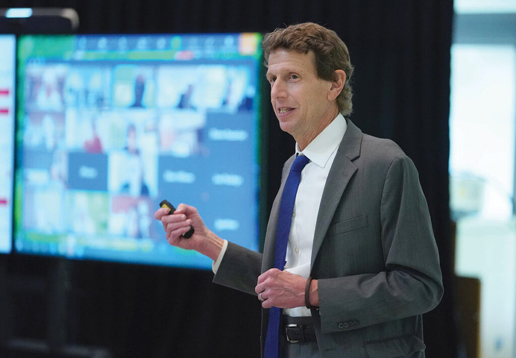COMMUNITY CONNECTIONS: Bryant University President Ross Gittell says one of his priorities is to maintain the strong community at the school, part of which involves connecting students to community service projects. / COURTESY BRYANT UNIVERSITY