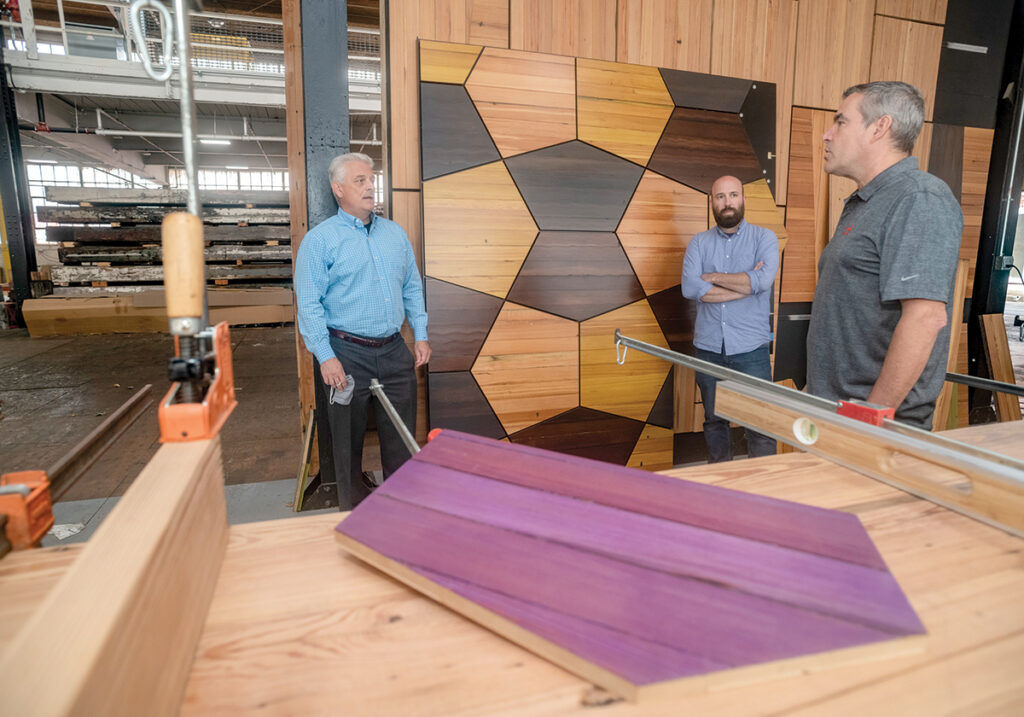 LOCATED AT 310 BOURNE AVE., Stephen E. Lane, right, owner of Ark Woods & Services LLC, has set up his business in Phillipsdale Landing, a former industrial site along the Seekonk River in East Providence. Lane speaks with Chris Martin, center, East Providence Waterfront Commission executive director, and William Fazioli, East Providence planning director and commission chairman. / PBN FILE PHOTO/MICHAEL SALERNO