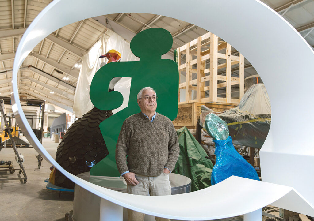 LOOKING UP: Paul Amaral, owner of Amaral Custom Fabrications Inc., a custom sculpture fabrication and restoration shop in East Providence, stands among several pieces he fabricated for various artists. Although he’s had difficulty filling positions at his shop, Amaral has plenty of interested clients and expects to grow his sales. / PBN PHOTO/RUPERT WHITELEY