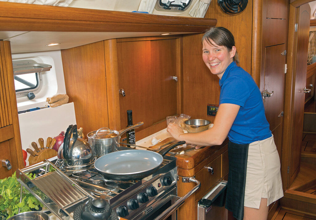 GALLEY MAVEN: Chef Jenny Baxter prepares a dish as part of the yacht chef competition at a previous Newport Charter Yacht Show. / COURTESY NEWPORT CHARTER YACHT SHOW/BILLY BLACK