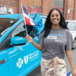 COMMUNITY SUPPORT:  Blue Cross & Blue Shield of Rhode Island Human Resources Business Partner Jess Nunez represents the company at the Dominican Parade of Rhode Island in Providence. / COURTESY BLUE CROSS  & BLUE SHIELD OF  RHODE ISLAND