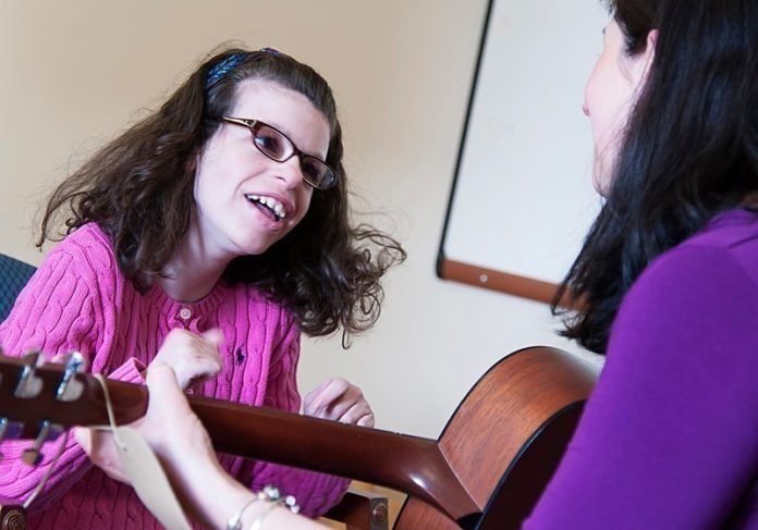 SWEET SOUNDS: Music therapist Nicole O’Malley works with client Maddie Manglass, a teenager who has been receiving music-therapy services for nearly 10 years. / PBN PHOTO/MICHAEL SALERNO SWEET SOUNDS: Music therapist Nicole O’Malley works with client Maddie Manglass, a teenager who has been receiving music-therapy services for nearly 10 years. / PBN PHOTO/MICHAEL SALERNO