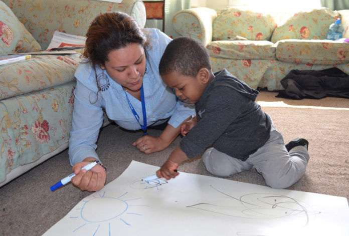 JENNIFER BONILLA of Providence’s Meeting Street works with Elias Castillo to help him practice fine-motor skills and matching shapes through the Healthy Families America Initiative. JENNIFER BONILLA of Providence’s Meeting Street works with Elias Castillo to help him practice fine-motor skills and matching shapes through the Healthy Families America Initiative.