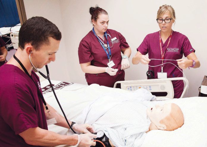 SIM CITY: Rhode Island College nursing students, from left, Andrew Sharpe, Heather Us-Spaziano and Amy Schnabel, train in the SIM lab. / COURTESY ?EUGENE ?ST. PIERRE