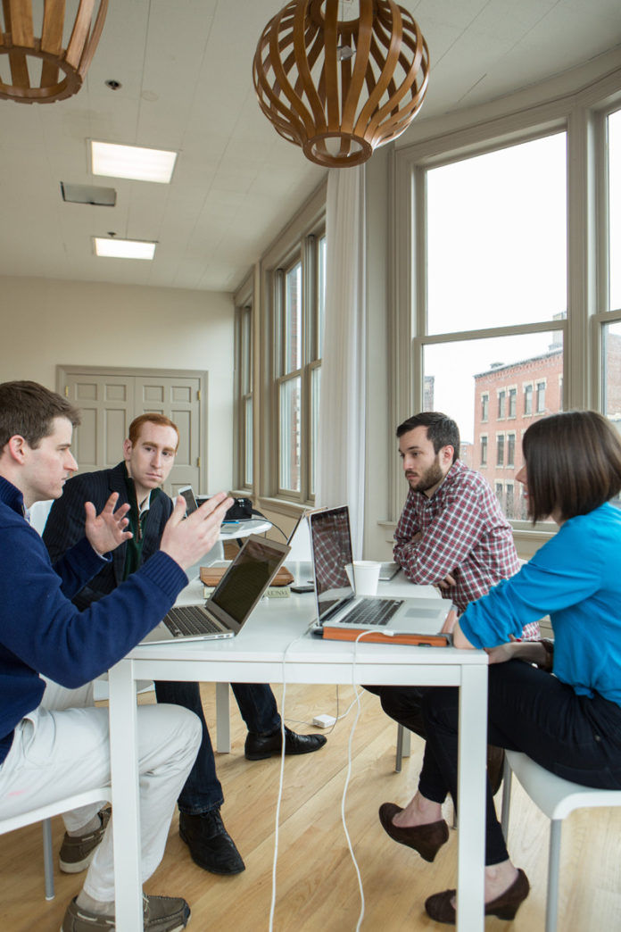 From left to right, CallRed co-founder Daniel Reilly and founder and CEO Andrew Kelley sit with Adam Croft and Sarah Cowan Johnson, of Intervarsity. / PBN PHOTO/RUPERT WHITELEY From left to right, CallRed co-founder Daniel Reilly and founder and CEO Andrew Kelley sit with Adam Croft and Sarah Cowan Johnson, of Intervarsity. / PBN PHOTO/RUPERT WHITELEY