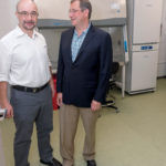 BIOTECH SUPPORT: Russ Yukhananov, left, president of Mansfield Bio-Incubator, and Alexander Margulis, chief operating officer, stand in front of one of their bio-safety cabinets. / PBN PHOTO/MICHAEL SALERNO