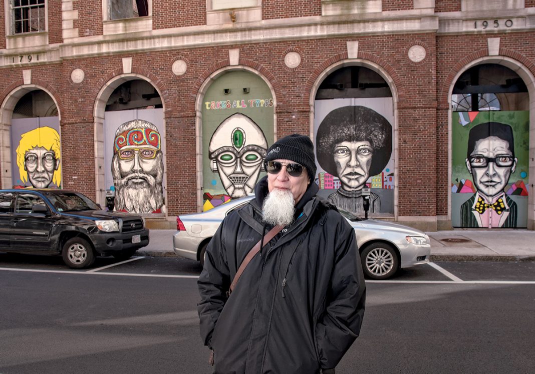 CELBRATING DIVERSITY: Bert Crenca, a Providence artist and founder of AS220, stands in front of “Types,” a series of five murals he painted on the historical façade of the Providence National Bank building at 35 Weybosset St, which is meant to celebrate the diversity of people. / PBN PHOTO/
MICHAEL SALERNO CELBRATING DIVERSITY: Bert Crenca, a Providence artist and founder of AS220, stands in front of “Types,” a series of five murals he painted on the historical façade of the Providence National Bank building at 35 Weybosset St, which is meant to celebrate the diversity of people. / PBN PHOTO/
MICHAEL SALERNO