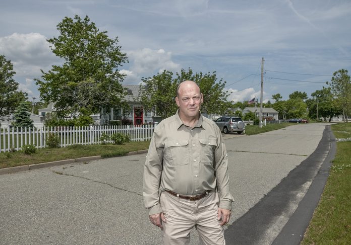 FLOOD-PRONE: Grover Fugate, executive director of the R.I. Coastal Resources Management Council, stands in front of properties on Strand Avenue in an at-risk area for flooding near the Oakland Beach neighborhood in Warwick.
/ PBN PHOTO/MICHAEL SALERNO FLOOD-PRONE: Grover Fugate, executive director of the R.I. Coastal Resources Management Council, stands in front of properties on Strand Avenue in an at-risk area for flooding near the Oakland Beach neighborhood in Warwick.
/ PBN PHOTO/MICHAEL SALERNO