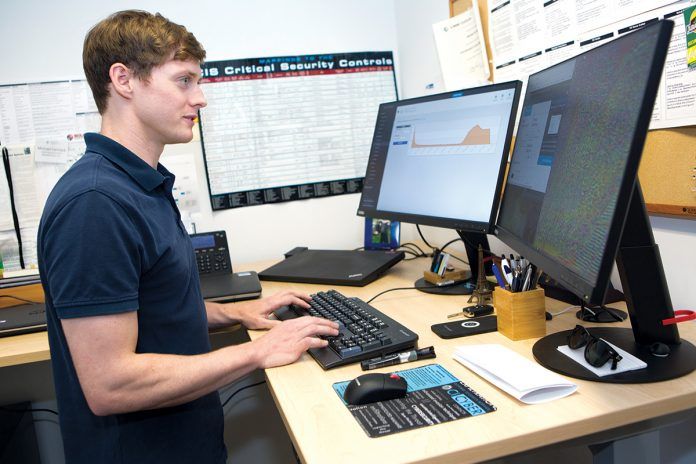 THREAT DETECTOR: Michael Carmack, a cybersecurity analyst with Rite-Solutions in Middletown, assesses security threats.
/ PBN PHOTO/KATE WHITNEY LUCEY THREAT DETECTOR: Michael Carmack, a cybersecurity analyst with Rite-Solutions in Middletown, assesses security threats.
/ PBN PHOTO/KATE WHITNEY LUCEY