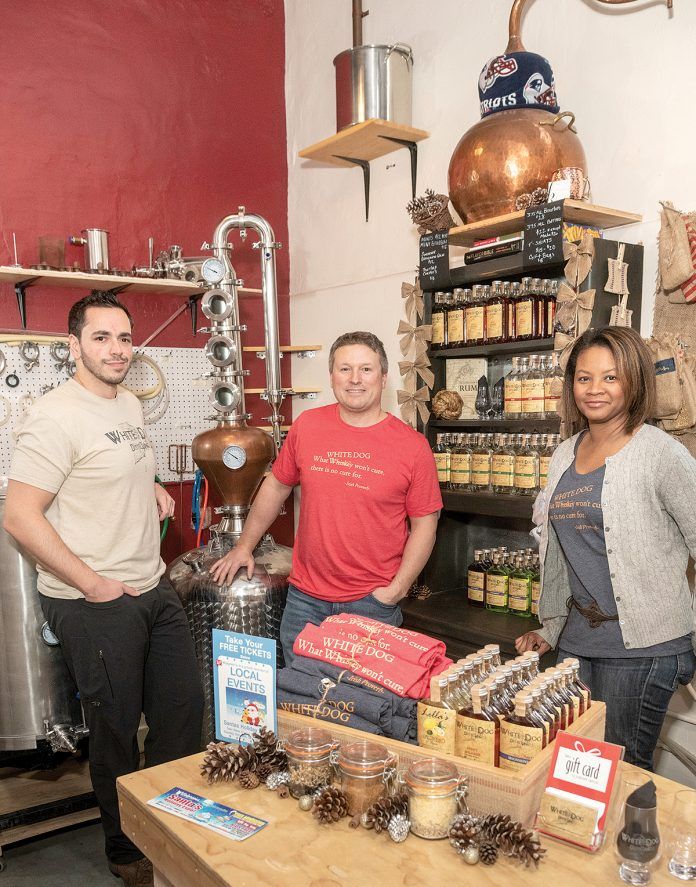 GROWING DISTILLERY: White Dog Distilling, incorporated as CAVE LLC, was founded in 2016 by Carlo Catucci, center, and his wife, Alecia, right, who partnered with longtime friends Eric Sylvestre, left, and Vin Greene, not pictured. Their micro-distillery and tasting room opened last April in a historic mill space in Pawtucket and will be moving to a larger retail location within the mill.
/ PBN PHOTO/MICHAEL SALERNO GROWING DISTILLERY: White Dog Distilling, incorporated as CAVE LLC, was founded in 2016 by Carlo Catucci, center, and his wife, Alecia, right, who partnered with longtime friends Eric Sylvestre, left, and Vin Greene, not pictured. Their micro-distillery and tasting room opened last April in a historic mill space in Pawtucket and will be moving to a larger retail location within the mill.
/ PBN PHOTO/MICHAEL SALERNO