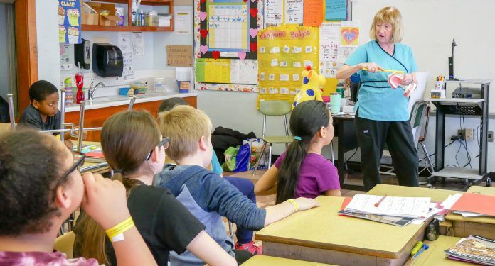 THUNDERMIST HEALTH CENTER dentist Mary McCabe teaches students about the importance of oral health at Citizens Elementary School in Woonsocket. / COURTESY THUNDERMIST HEALTH CENTER