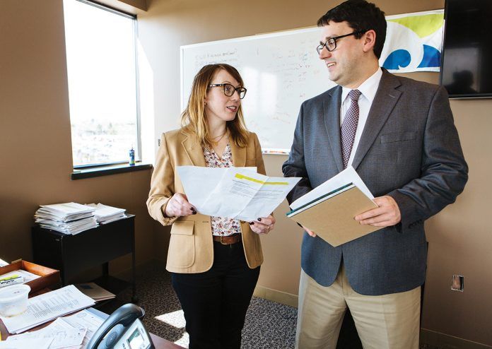 RECENT IMPROVEMENTS: HealthSource RI Director Zachary W. Sherman speaks with Robin Dionne, HSRI chief public affairs officer. Sherman said recent improvements to the HSRI for Employers program include technology advances that have allowed HSRI to connect employers with ancillary products to supplement health and dental plans.
 / PBN PHOTO/RUPERT WHITELEY RECENT IMPROVEMENTS: HealthSource RI Director Zachary W. Sherman speaks with Robin Dionne, HSRI chief public affairs officer. Sherman said recent improvements to the HSRI for Employers program include technology advances that have allowed HSRI to connect employers with ancillary products to supplement health and dental plans.
 / PBN PHOTO/RUPERT WHITELEY