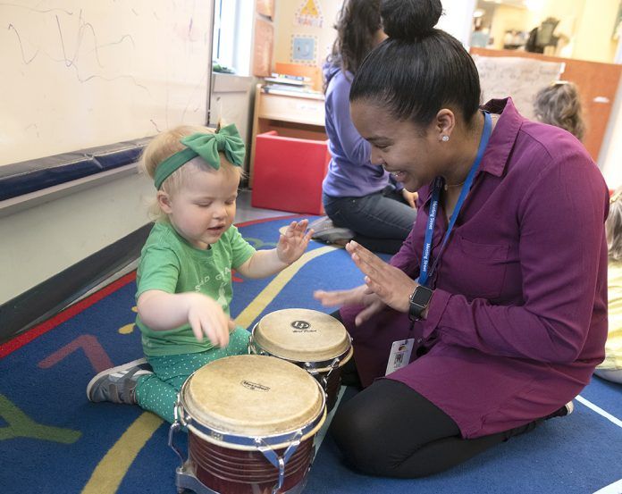 PERCUSSION SKILLS: Meeting Street teacher’s assistant Ruth Espinal, right, practices percussion skills with Cameron Cuddy at the Early Learning Center.
 / PBN PHOTO/MICHAEL SALERNO PERCUSSION SKILLS: Meeting Street teacher’s assistant Ruth Espinal, right, practices percussion skills with Cameron Cuddy at the Early Learning Center.
 / PBN PHOTO/MICHAEL SALERNO