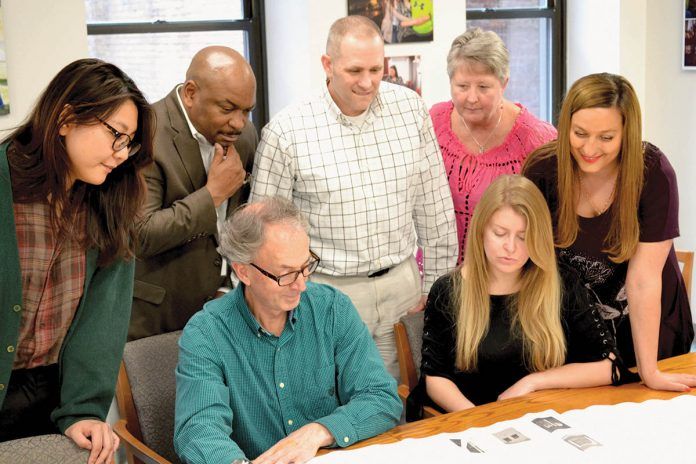 COLLABORATIVE TASK: Staff members from several R.I. Housing departments review plans for a housing development. 
 / COURTESY R.I. HOUSING AND MORTGAGE FINANCE CORP. COLLABORATIVE TASK: Staff members from several R.I. Housing departments review plans for a housing development. 
 / COURTESY R.I. HOUSING AND MORTGAGE FINANCE CORP.