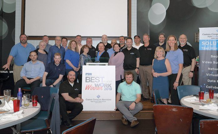 HAPPY OCCASION: Employees at Custom Computer Specialists mark the company being named one of the 2019 PBN Best Places To Work.  / COURTESY CUSTOM COMPUTER SPECIALISTS 