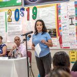 GETTING INVOLVED: Parent Yulaana Perez speaks during a public forum on the Johns Hopkins Institute for Education Policy report on Providence schools. R.I. education commissioner Angélica Infante-Green and Mayor Jorge O. Elorza listen in the background. / PBN PHOTO/MICHAEL SALERNO
