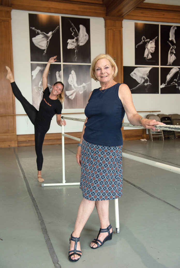 ON THE MOVE: Island Moving Company founder and Artistic Director Miki Ohlsen, with company dancer Emily Baker in the background. The ballet performance company is planning and fundraising for a new $4 million building that would include three studios as a black box theater and provide a home for its Newport Academy of Ballet.
/ PBN PHOTO/DAVE HANSEN ON THE MOVE: Island Moving Company founder and Artistic Director Miki Ohlsen, with company dancer Emily Baker in the background. The ballet performance company is planning and fundraising for a new $4 million building that would include three studios as a black box theater and provide a home for its Newport Academy of Ballet.
/ PBN PHOTO/DAVE HANSEN