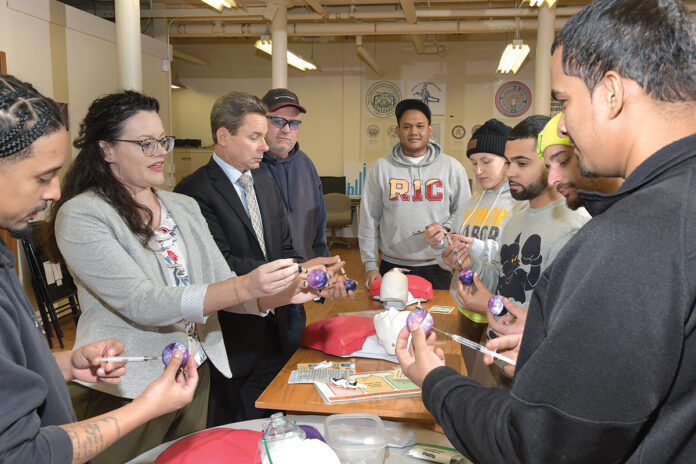 HANDS-ON TRAINING: Jill Sypole, second from left, Building Futures health initiatives manager, and Andrew Cortés, third from left, the group’s executive director, stage a training event in Providence on how to administer Narcan to someone who has overdosed.
/ PBN PHOTO/MIKE SKORSKI HANDS-ON TRAINING: Jill Sypole, second from left, Building Futures health initiatives manager, and Andrew Cortés, third from left, the group’s executive director, stage a training event in Providence on how to administer Narcan to someone who has overdosed.
/ PBN PHOTO/MIKE SKORSKI