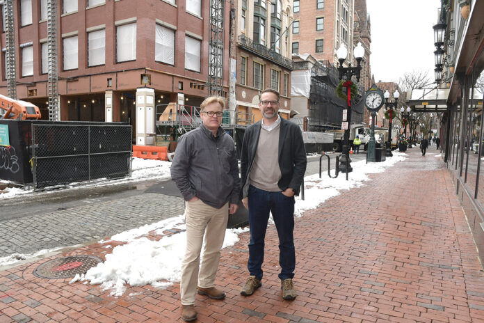 TAKING SHAPE: Architects Donald Powers, left, and Douglas Kallfelz, of Union Studio Architecture & Community Design, outside a three-building project the firm designed on Westminster Street in Providence. / PBN PHOTO/MIKE SKORSKI