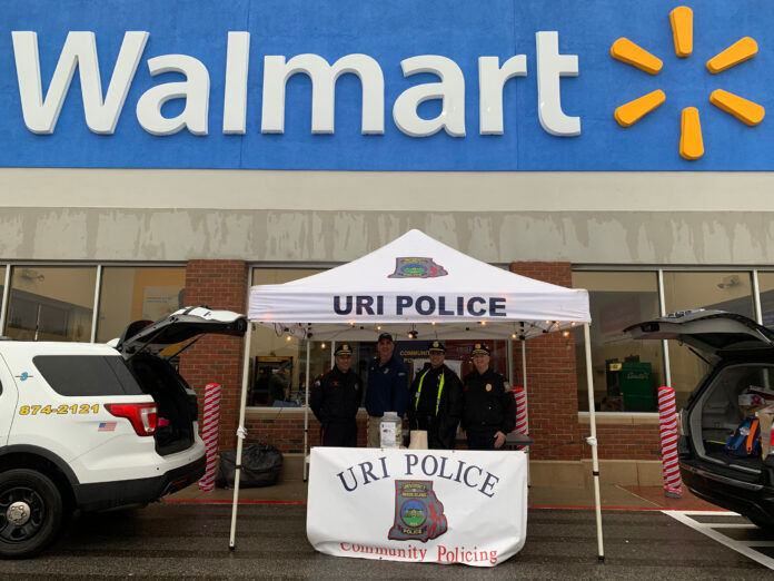 UNIVERSITY OF RHODE ISLAND police officers collect items in front of Walmart on Ten Rod Road in North Kingstown as part of the department’s annual Stuff-a-Cruiser toy drive. Pictured, from left, are URI Police Maj. Michael Jagoda, Officer Paul Hanrahan, Det. Mark Brasil and Capt. Michael Chalek. / COURTESY URI POLICE SGT. ERICA VIEIRA