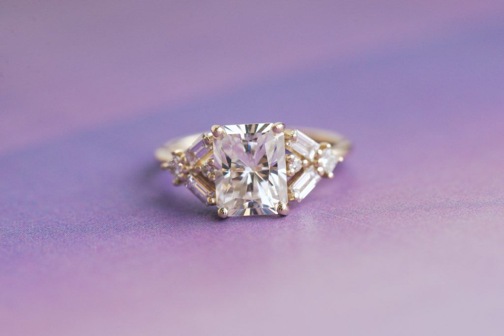 moissanite vs lab grown diamond, radiant moissanite engagement ring featuring a variety of lab diamonds including round, princess, and baguettes
