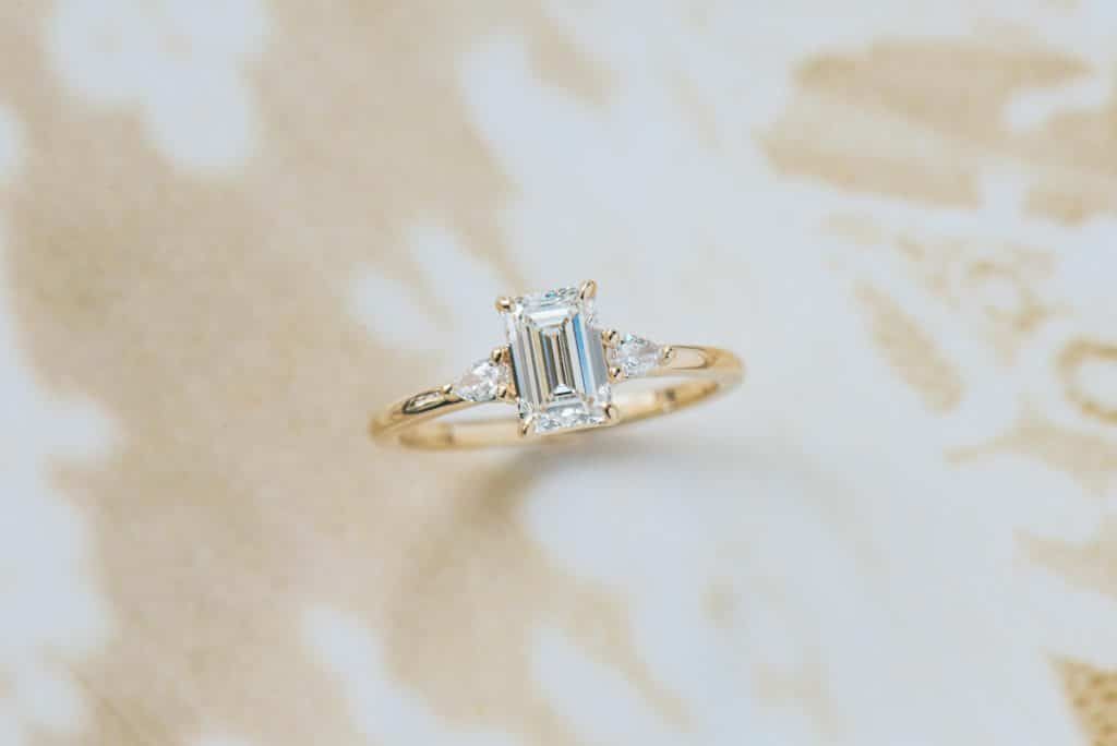 emerald cut 3 stone engagement ring