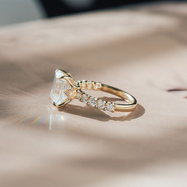 Emerald Moissanite Engagement Ring With Petal Prongs And Pavé-side