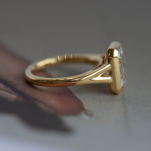 Bezel Set Emerald Engagement Ring With Split-Shank Band-side