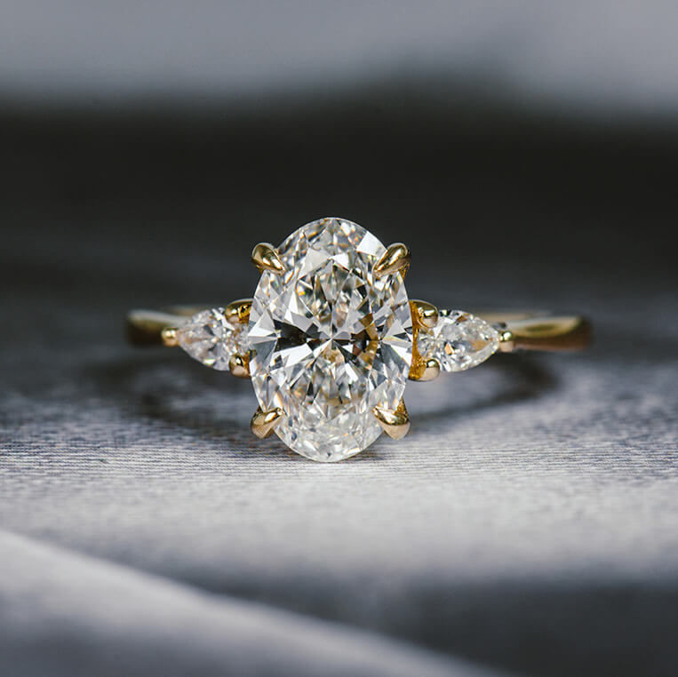 oval and pear 3 stone engagement ring