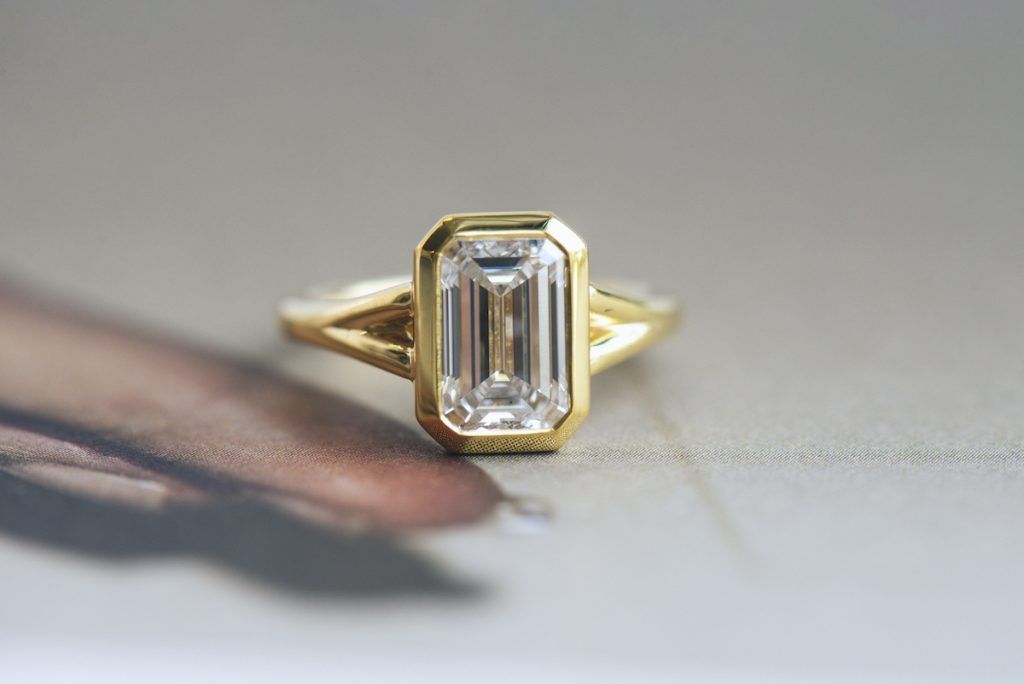 art deco engagement rings - bezel set emerald cut lag-grown diamond